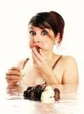 Woman eating sweets - looks like she's getting caught